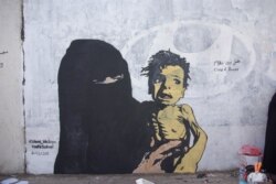 FILE - A mural named "A Boy of Bones," painted by Yemeni artist Haifa Subay. The mural seeks to warn about the risk of famine, which is threatening the lives of millions of children in Yemen.