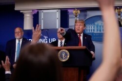 FILE - President Donald Trump points to a reporter to ask a question as he speaks about the coronavirus in the James Brady Press Briefing Room of the White House, in Washington, April 16, 2020.