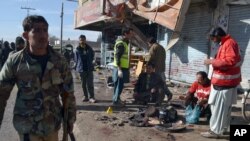 Pakistani police officers and rescue workers gather at the site of suicide bombing in Quetta, Pakistan, Wednesday, Jan. 13, 2016.
