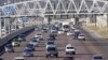 Cars stream underneath a gantry on a road to Pretoria, South Africa, May 4, 2012. 