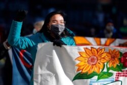 FILE - Tenants' rights advocates march from the Edward W. Brooke Courthouse, Jan. 13, 2021, in Boston. The protest called on the incoming Biden administration to extend the eviction moratorium initiated in response to the COVID-19 pandemic.