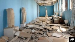FILE - This file photo released March 27, 2016, by the Syrian official news agency shows destroyed statues at the damaged Palmyra Museum, in the city of Palmyra, Syria. Palmyra, the archaeological gem that Islamic State fighters retook Dec. 11, 2016, from