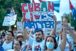 FILE - Demonstrators gather outside The White House on July 17, 2021 protesting against the Cuban government — demanding assistance from the Biden administration to help free Cuban citizens from oppression.