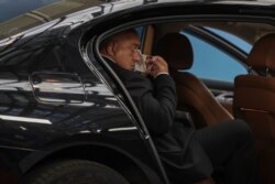 FILE - Bulgaria's then-prime minister Boyko Borissov puts on a protective face mask as he arrives for the fourth day of an EU summit at the European Council building in Brussels, July 20, 2020.