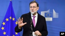 FILE - Spanish Prime Minister Mariano Rajoy speaks with the media as he arrives for a meeting at EU headquarters in Brussels on Feb. 23, 2018. 
