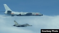 FILE - A Taiwanese fighter jet flew close to a Chinese H-6 bomber in 2017.