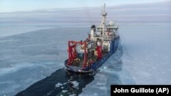 In this Nov. 14, 2019, photo provided by John Guillote the U.S. research ship Sikuliaq travels through sea ice in the Beaufort Sea off Alaska's north coast. 