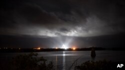 A SpaceX Falcon 9 rocket with the company's Crew Dragon spacecraft onboard is seen illuminated by spotlights on the launch pad at Launch Complex 39A, Saturday, Nov. 14, 2020, at NASA's Kennedy Space Center, at Cape Canaveral, Fla.