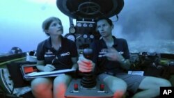 Lucy Woodall, Nekton Mission principle scientist, left, and pilot Randy Holt inside a submersible 60 meters below surface of Indian Ocean during a descent into the Indian Ocean off Alphonse Atoll near the Seychelles, Tuesday March 12, 2019.