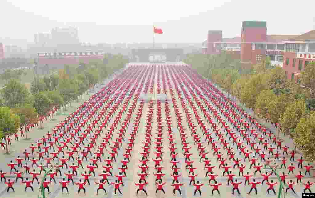 Students practice Taichi on a playground of a high school, during a Guinness World Record attempt of the largest martial arts display, on a hazy day in Jiaozuo, Henan province, China, Oct. 18, 2015.