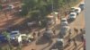 In this image made available by Malikahere.com security personnel, right, arrive close to the scene of an attack on a hotel in Bamako, Mali, Nov. 20, 2015. 