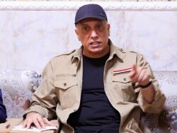 FILE - Iraqi Prime Minister Mustafa al-Khadhimi speaks to locals in Tarmiyah, Iraq, July 20, 2020. (Khalid Mohammed/Pool via Reuters)