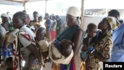 Women who fled fighting in South Sudan wait with their children for the immunization of their children on arrival at Bidi Bidi refugee’s resettlement camp near the border with South Sudan, in northern Uganda, Dec. 7, 2016.