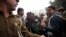 Police officials escort an accused in the gang rape of a 51-year-old Danish tourist to produce him in court in New Delhi, India, Jan. 16, 2014.