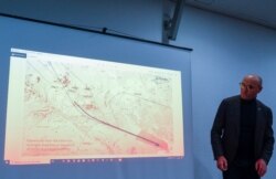 Ukraine International Airlines President Yevhenii Dykhne stands next to a map of Flight PS-752's departure path at a briefing about the crash of the plane on the outskirts of Tehran, at Boryspil International Airport in Ukraine, Jan. 11, 2020.