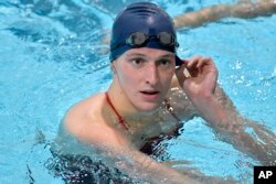 FILE - Transgender swimmer Lia Thomas speaks to her coach after winning the 500 meter freestyle during a meet with Harvard on Jan. 22, 2022, at Harvard University in Cambridge, Mass. (AP Photo/Josh Reynolds, File)