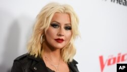 FILE - Christina Aguilera arrives at Season 8 of "The Voice" Red Carpet Event in West Hollywood, California, April 23, 2015.