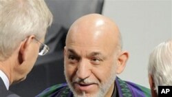Afghan President Hamid Karzai talks with delegates during the International Conference on Security Policy in Munich, southern Germany, February 6, 2011.