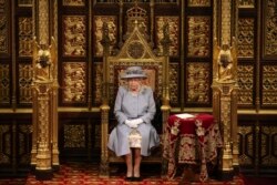 FILE - Britain's Queen Elizabeth II delivers a speech in the House of Lords during the State Opening of Parliament, at the Palace of Westminster in London, May 11, 2021.