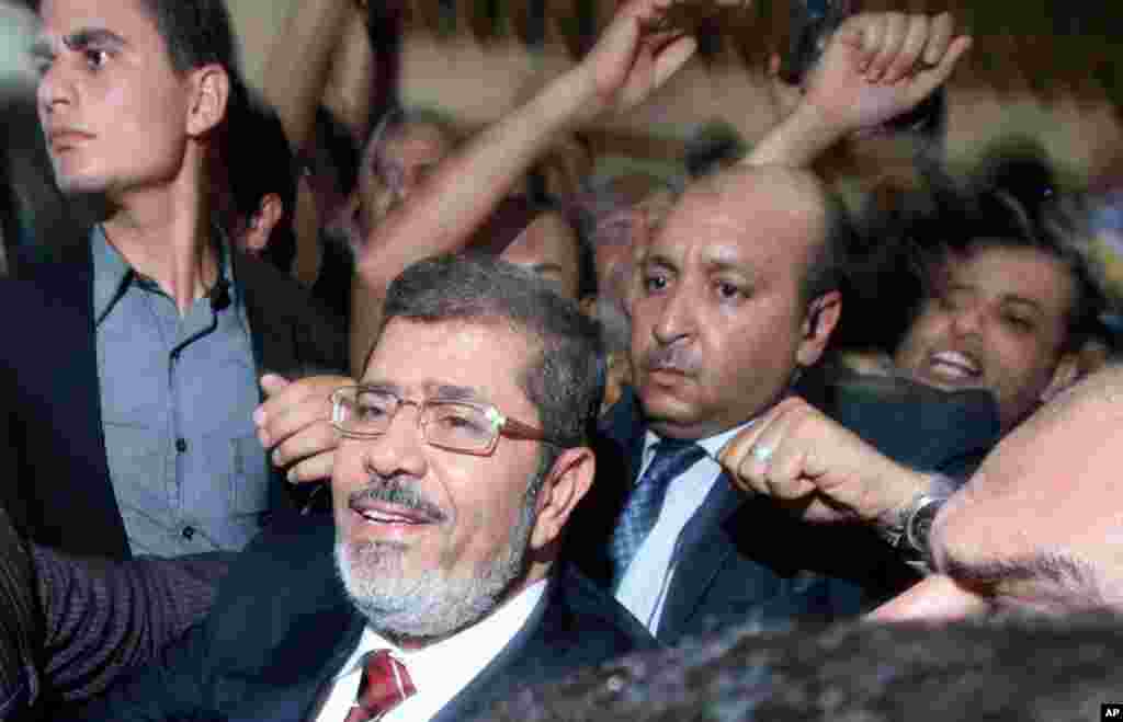 Mohammed Morsi and his supporters celebrate his victory at his campaign headquarters in Cairo, June 18, 2012.