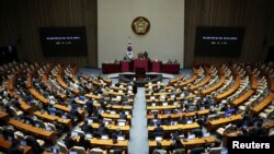 4일 한국 국회의원들이 윤석열 한국 대통령의 비상계엄 선포 이후 의회 내부에 착석해 있다.