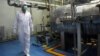 FILE - An Iranian technician walks through the Uranium Conversion Facility in Iran in February 2007. 
