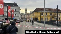 People look into a cordoned off area where a 23-year-old man stabbed several people in the southern Austria city of Villach, Feb. 15, 2025. (Wiesflecker/Kleine Zeitung via AP)