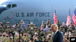 President Joe Biden speaks to American service members at RAF Mildenhall in Suffolk, England, June 9, 2021, after arriving in Europe for meetings with U.S. allies and Russian President Vladimir Putin. 