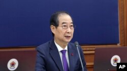 South Korea's Prime Minister Han Duck-soo, who became the country's acting leader after President Yoon Suk Yeol's impeachment, speaks during a Cabinet meeting at the government complex in Seoul, Dec. 17, 2024. (Hong Hae-in/Yonhap via AP)