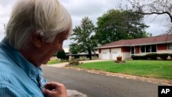 FILE - Democratic organizer Bill Chandler reviews a voter contact sheet while canvassing, Sept. 21, 2019, in Whitewater, Wis. Democrats hope to win back Wisconsin by rebuilding the infrastructure they let crumble ahead of the last presidential election.