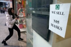 A woman walks into a pharmacy to purchase N95 face masks in advance of the potential coronavirus outbreak in the Manhattan borough of New York City, Feb. 27, 2020.