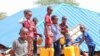 Children are filling their water containers at the makeshift Camp for Yemeni refugees near the Somali capital Mogadishu. (Courtesy of Muslim Aid)