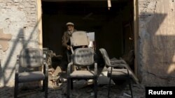 Indonesian villager Mama Hasria swims upstream with about 200 empty jerry cans tied to her back, a daily trip she and other local women make to get clean water for their community on Sulawesi island.