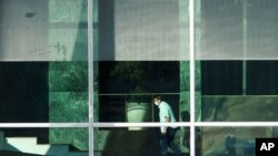 Brazil's President Jair Bolsonaro ascends a flight of stairs at his official residence Alvorada Palace, in Brasilia, Brazil, July 14, 2020.