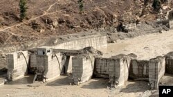A view of the remains of Tapovan Hydro-Electric Power Dam that was swept away after part of a Himalayan glacier broke off Sunday sending a devastating flood downriver in Tapovan area of the northern state of Uttarakhand, India, Feb.9, 2021. 