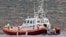 Italian Coast Guard personnel load a body bag on their patrol boat off Lampedusa island, Oct. 8, 2013. 