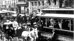 Horse-drawn wagons and electric trolley cars share the streets in 1897 Philadelphia during a time of revolutionary change in transportation and industry