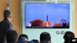 People watch a TV screen showing file footage of North Korea's missile launch at Seoul Railway Station in Seoul, South Korea, Nov. 21, 2017.