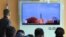 People watch a TV screen showing file footage of North Korea's missile launch at Seoul Railway Station in Seoul, South Korea, Nov. 21, 2017.
