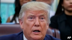 FILE - President Donald Trump speaks from the Oval Office of the White House in Washington, July 17, 2019.