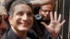 Bassem Youssef, Egyptian TV satirist, waves to supporters in Cairo before talks with authorities about charges he insulted Islam and the nation's president, March 31, 2013.