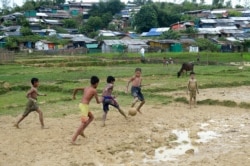Rohingya refugee children play football at Thankhali refugee camp, in Ukhia on Oct. 6, 2020.