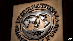 FILE - The logo of the International Monetary Fund is visible on its building in Washington, April 5, 2021.