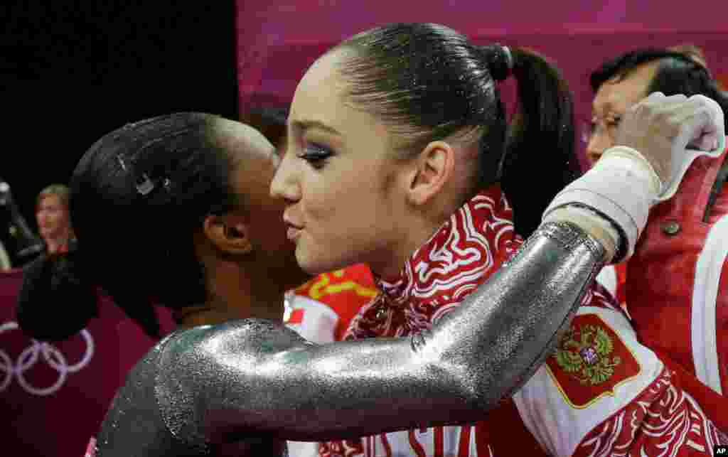 U.S. gymnast Gabrielle Douglas, left, congratulates Russia's Aliya Mustafina for winning the gold for the uneven bars during the artistic gymnastics women's apparatus finals.