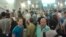 In this image made with a mobile phone camera, people leave a subway station in Moscow Wednesday, June 5, 2013. A rush-hour fire in Moscow’s subway injured dozens of people, forced the evacuation of thousands of commuters.