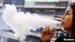Patthasorn Kleespies of German e-cigarette manufacturer Eazzi tests a new vaping cigarette at the company headquarters in Gelnhausen, Germany, January 29, 2019. (REUTERS/Kai Pfaffenbach)