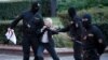 Opposition activist Nina Baginskaya, 73, struggles with police during a Belarusian opposition supporters rally at Independence Square in Minsk, Belarus, Aug. 26, 2020. Police have dispersed protesters, detaining dozens.