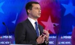 Democratic presidential candidate South Bend Mayor Pete Buttigieg points to his wedding ring from his marriage to his husband, Chasten, as he talks about civil rights in the United States during the U.S. Democratic presidential candidates debate.