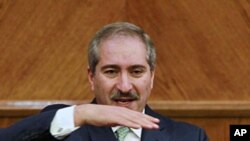 Jordan's Foreign Minister Nasser Judeh speaks to the media after his meeting with Israeli and Palestinian negotiators alongside international mediators trying to revive their stalled peace talks after more than a year of deadlock in Amman, January 3, 2012