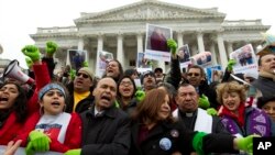FILE - Rep. Luis Gutierrez (D-Illinois), third from left, along with other demonstrators protest outside of the U.S. Capitol in support of the Deferred Action for Childhood Arrivals (DACA) during a rally on Capitol Hill in Washington, Dec. 6, 2017.